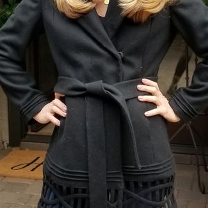 Black wool pea coat with unique cutouts at bottom. Very gently worn.